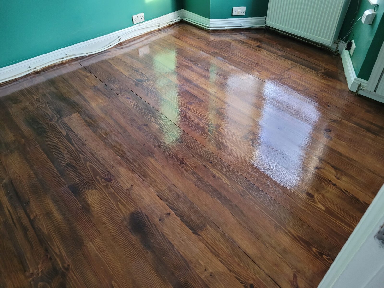 Floor-Sanding-and-Dark-Stains-Dark-Stained-Wooden-Floor-with-Glossy-Finish